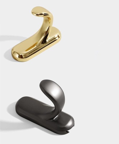 Wandhaken Bello – eleganter Haken mit geschwungener Form aus robustem Metall. Ideal für Flur, Bad und Garderobe. Farben: glänzendes Gold und Perlgrau. Montageschrauben im Set.