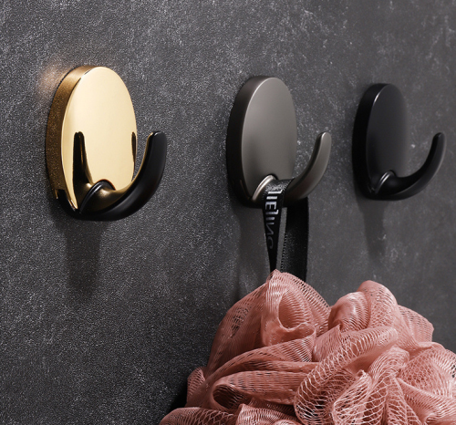 Wandhaken Lucia – moderner, robuster und feuchtigkeitsbeständiger Wandhaken mit einfacher Schraubmontage. Ideal für Bad, Küche und Flur zu Hause oder im Objektbereich. Farben: Schwarz, Perlgrau, Gold und Gold-Schwarz.